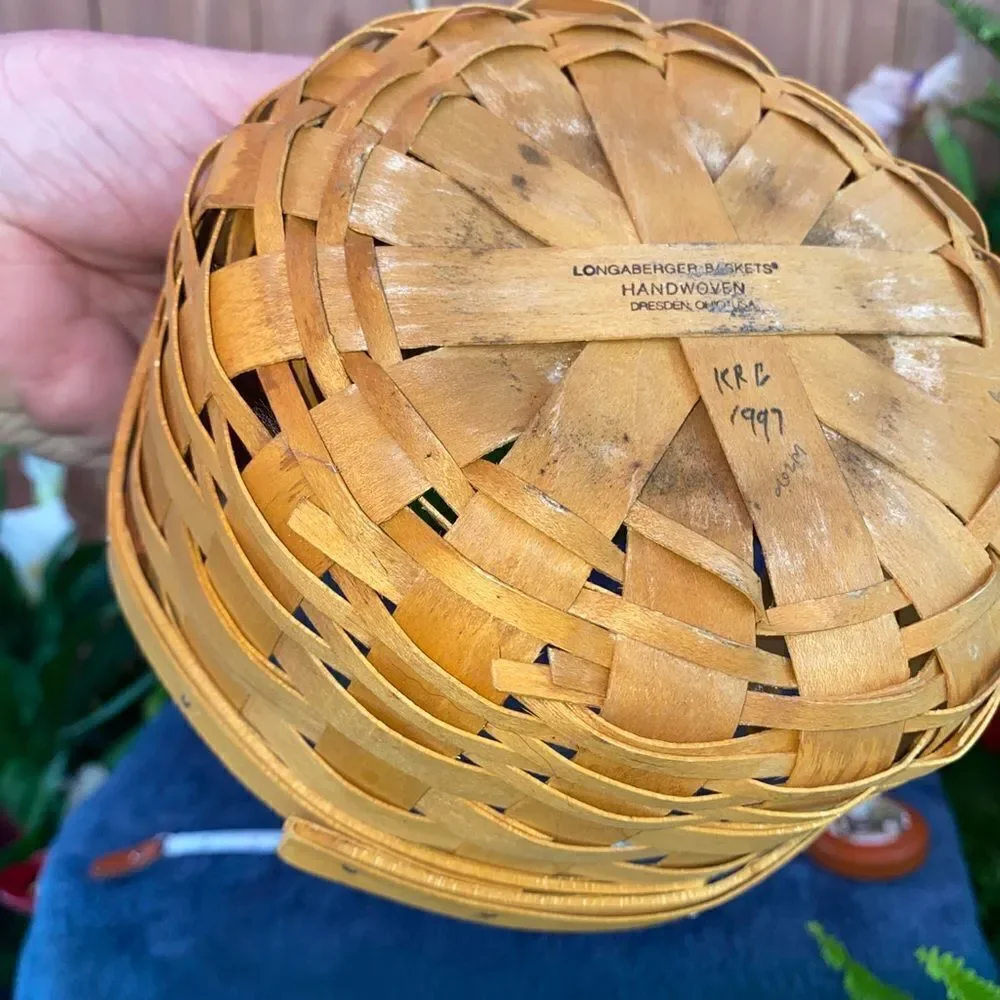 Circular basket with plastic insert and leather handles by Longaberger